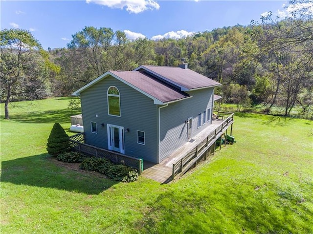 exterior space with a deck and a lawn