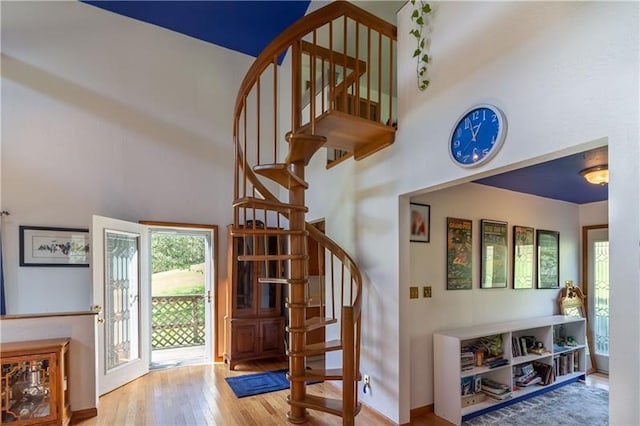 foyer entrance featuring a high ceiling and light hardwood / wood-style flooring