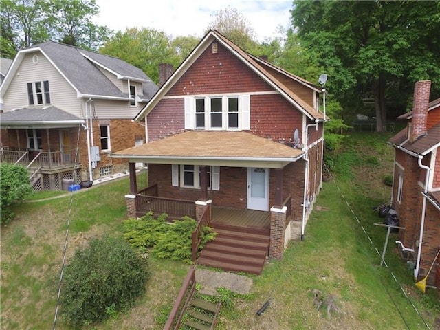 view of front of property featuring covered porch and a front lawn