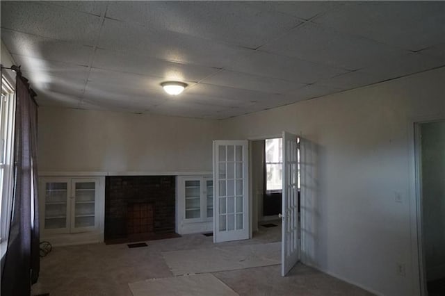 unfurnished living room featuring french doors