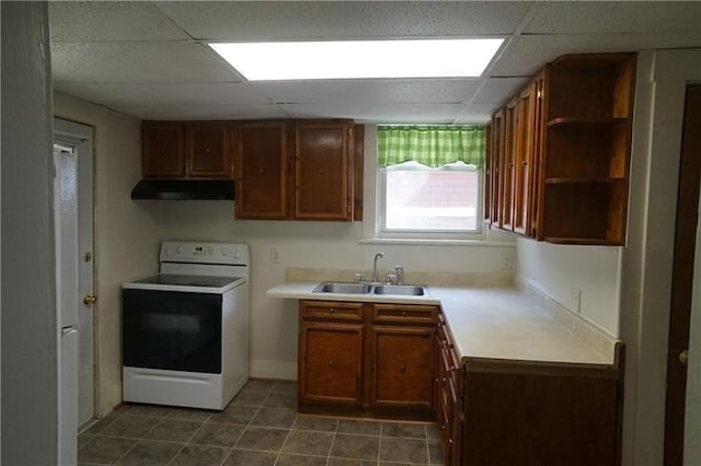 kitchen with dark tile flooring, electric stove, a drop ceiling, and sink