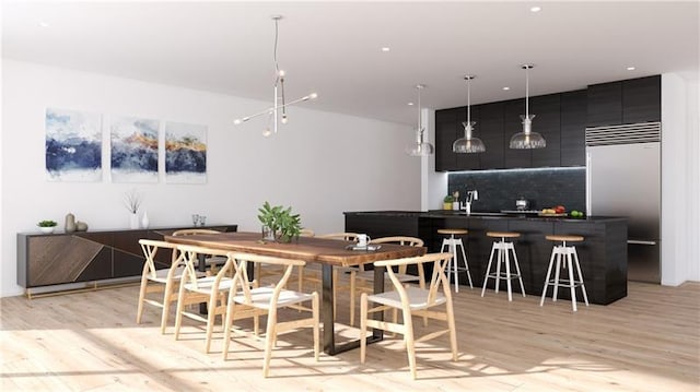 dining area featuring light hardwood / wood-style flooring and sink