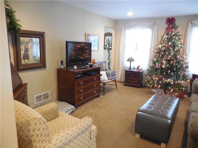 living room featuring plenty of natural light and light colored carpet