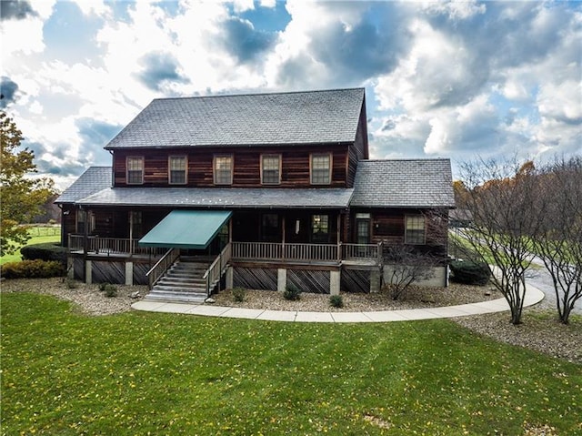 rear view of property with a lawn