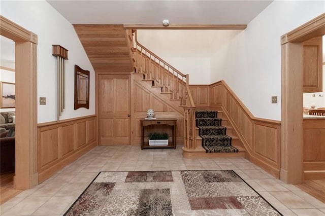 unfurnished living room featuring light tile floors