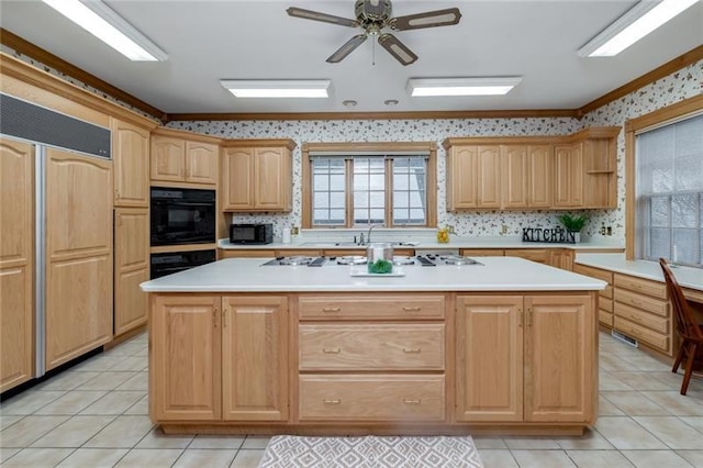 kitchen featuring ceiling fan, black appliances, a center island, and light tile floors