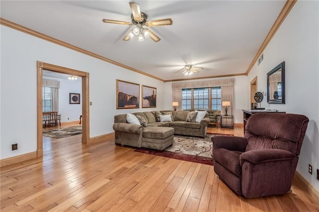 living room featuring light hardwood / wood-style flooring, ceiling fan, and ornamental molding