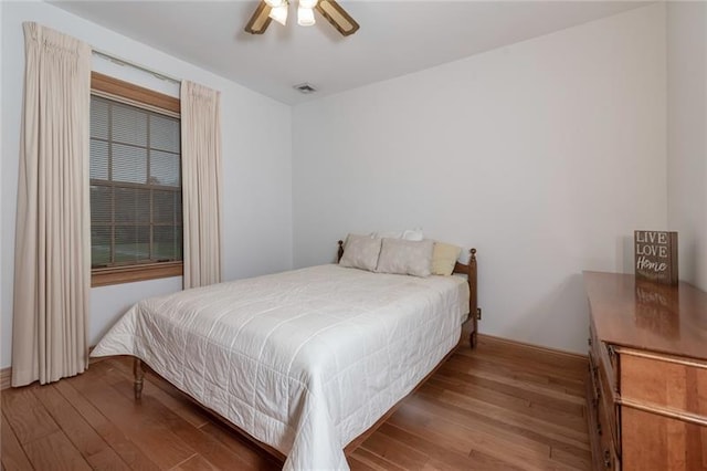 bedroom with ceiling fan and wood-type flooring