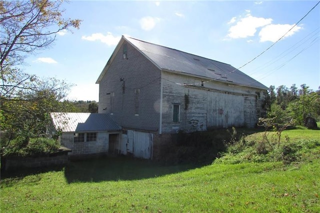 view of side of home with a lawn