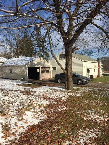 snow covered property featuring a garage