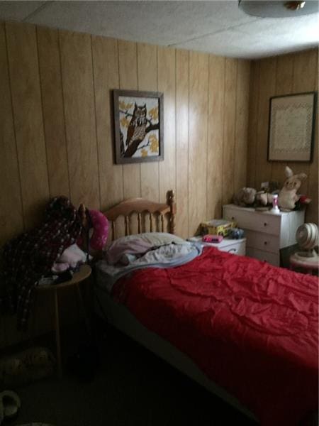 bedroom with wood walls