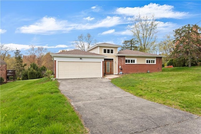 view of front of property featuring a front yard and a garage