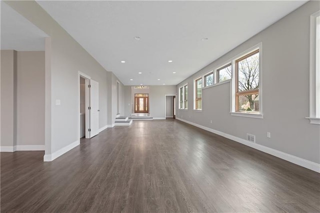 unfurnished living room with dark hardwood / wood-style flooring