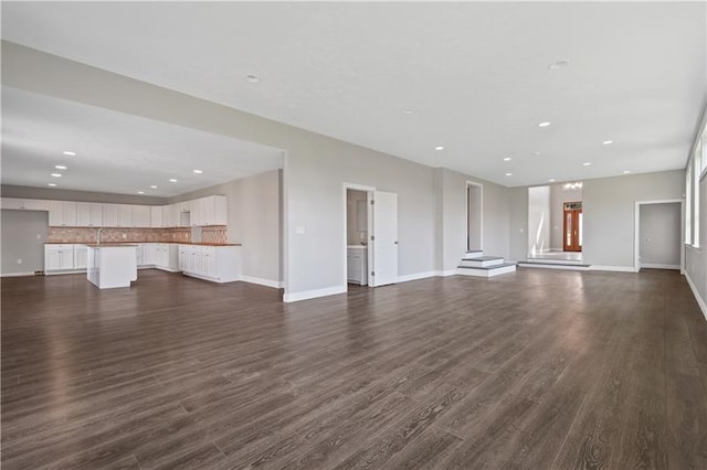 unfurnished living room with dark hardwood / wood-style floors