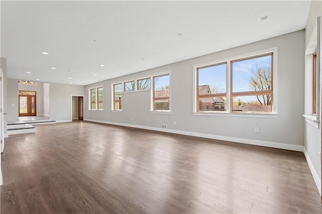 unfurnished living room with dark hardwood / wood-style floors