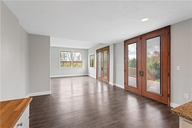 empty room featuring dark hardwood / wood-style floors and french doors