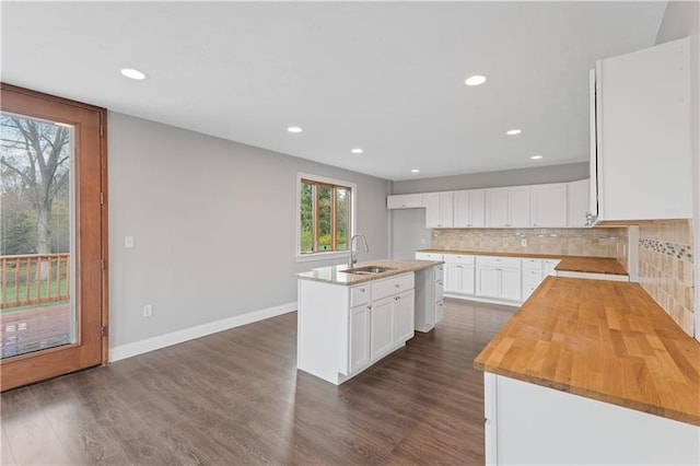 kitchen featuring tasteful backsplash, a center island with sink, white cabinetry, dark hardwood / wood-style floors, and sink