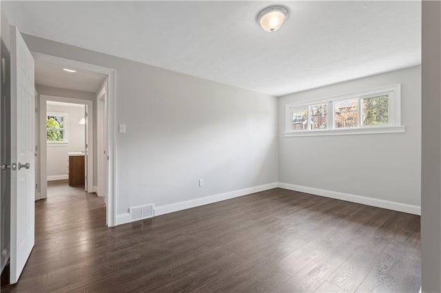 empty room with dark wood-type flooring