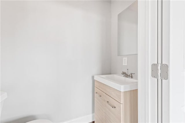 bathroom with toilet and vanity