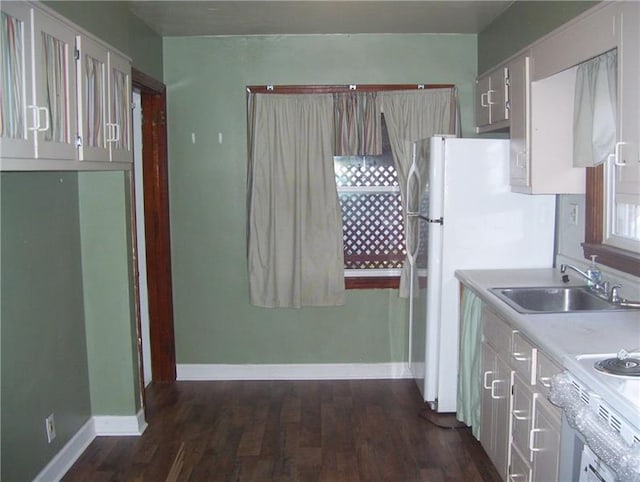 kitchen with white fridge, sink, and dark hardwood / wood-style floors