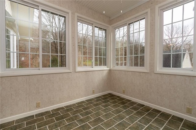 unfurnished sunroom with plenty of natural light