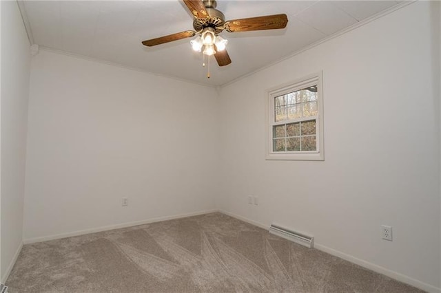 spare room with ceiling fan, crown molding, and carpet floors