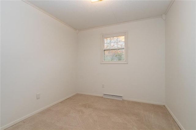 spare room featuring light colored carpet and ornamental molding