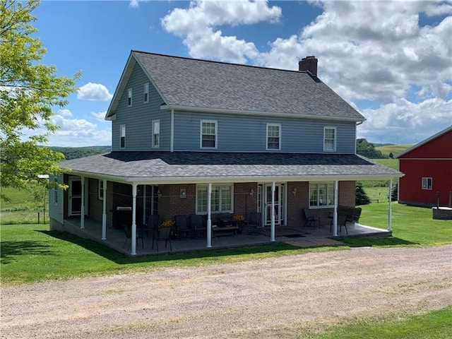 rear view of house with a lawn