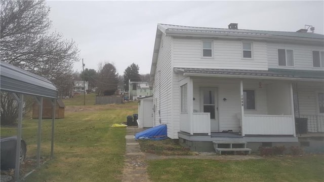 view of property exterior with covered porch and a lawn