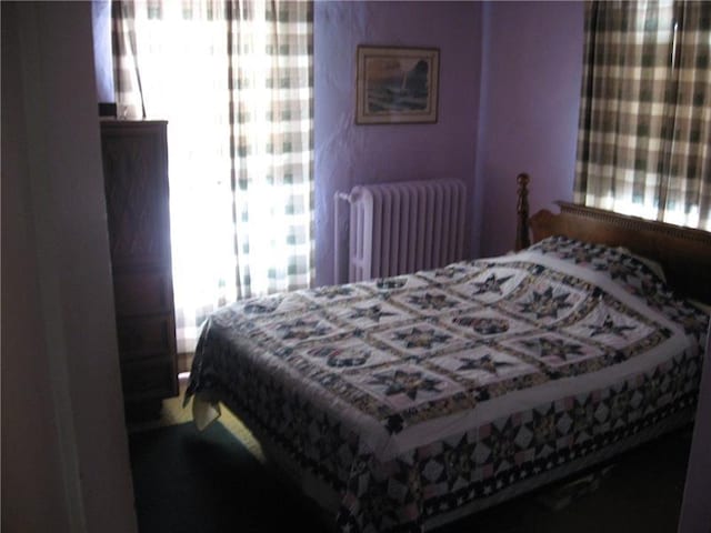 bedroom featuring radiator heating unit