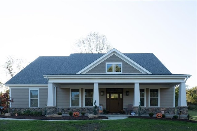 view of front of house with covered porch and a front yard