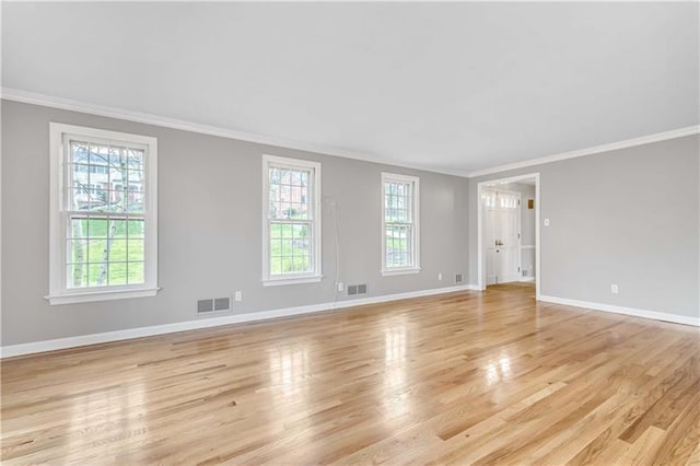 unfurnished room with plenty of natural light, light hardwood / wood-style floors, and ornamental molding