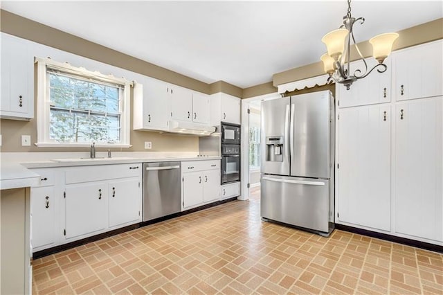 kitchen featuring an inviting chandelier, white cabinetry, black appliances, and pendant lighting