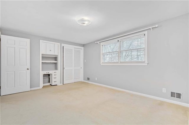 unfurnished bedroom with light colored carpet