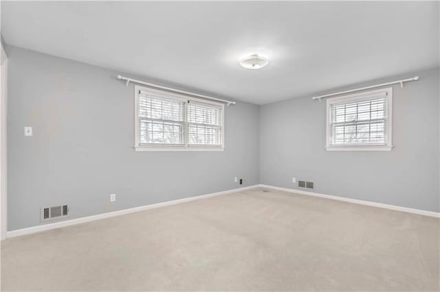 unfurnished room with light colored carpet