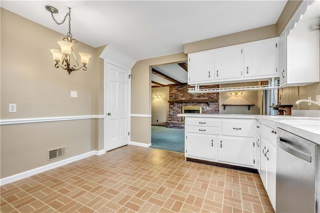 kitchen featuring an inviting chandelier, white cabinets, pendant lighting, and stainless steel dishwasher