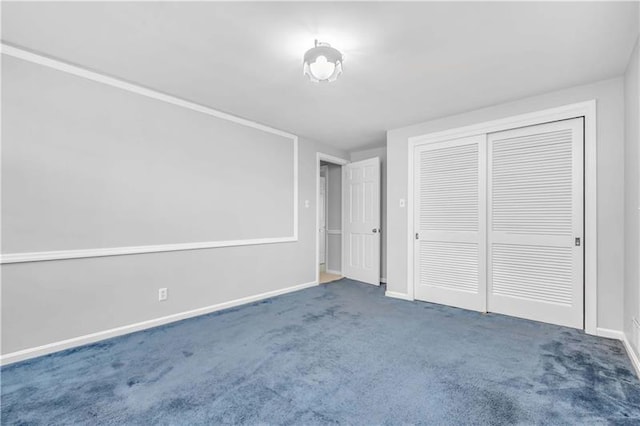 unfurnished bedroom featuring a closet and dark colored carpet