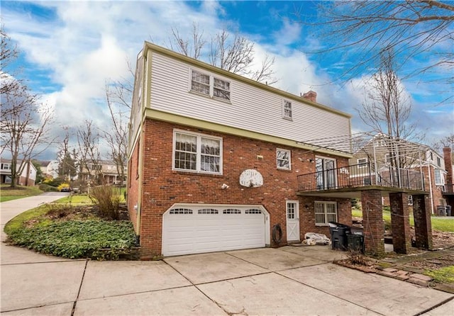 back of property with a balcony and a garage