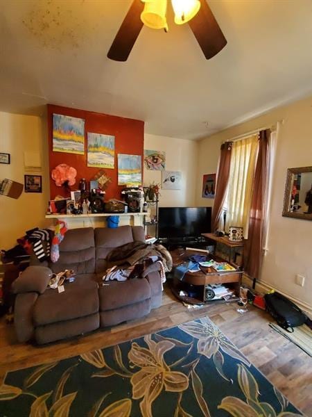 living room featuring wood-type flooring and ceiling fan