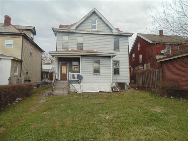 rear view of property with a yard