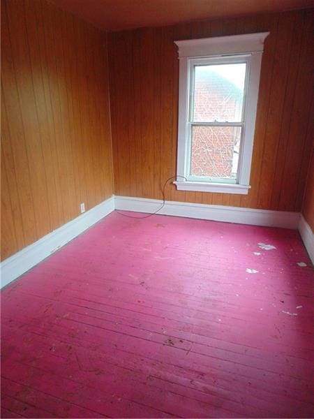 empty room with hardwood / wood-style floors