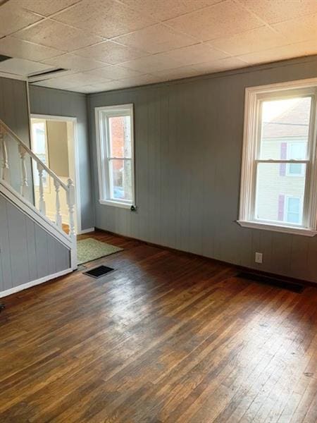 empty room featuring dark hardwood / wood-style floors and a wealth of natural light