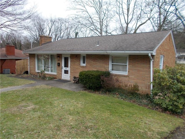 single story home with a front yard and central air condition unit