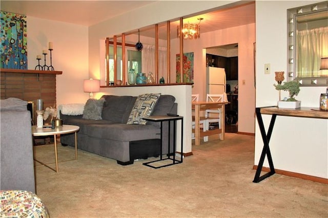 carpeted living room with a notable chandelier