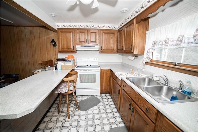 kitchen with light tile flooring, ceiling fan, wooden walls, white electric stove, and sink