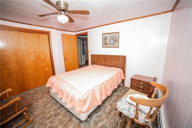 carpeted bedroom with ceiling fan and a closet