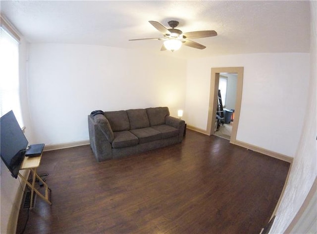 living room with ceiling fan and dark hardwood / wood-style floors