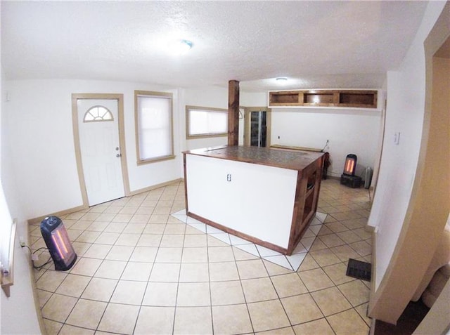 kitchen with light tile floors and a textured ceiling