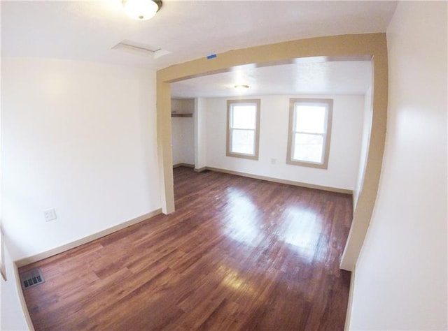 empty room featuring dark hardwood / wood-style flooring