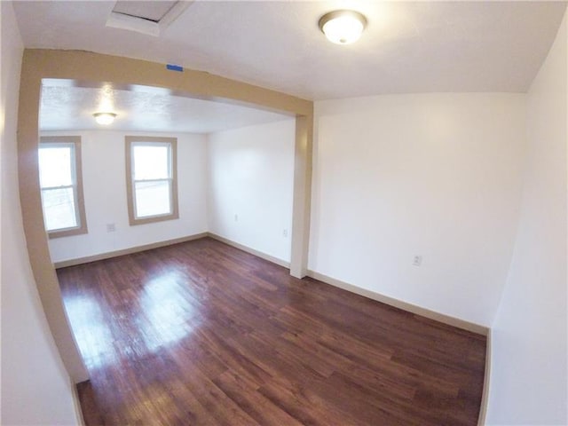 unfurnished room featuring dark wood-type flooring